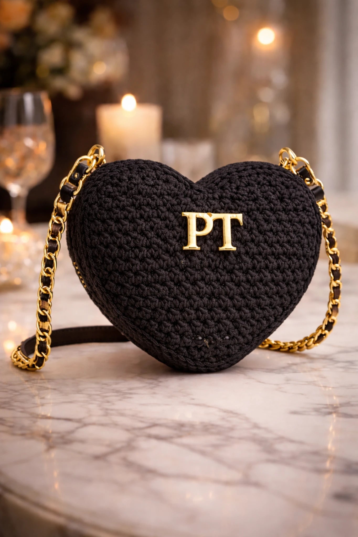 PT Cherie Bag - Pearl & TickPT Cherie BagHandbagsPearl & TickPearl & TickCHERIE-BLKBlackBlack heart - shaped handbag with gold chain strap and initials on a marble surface.
