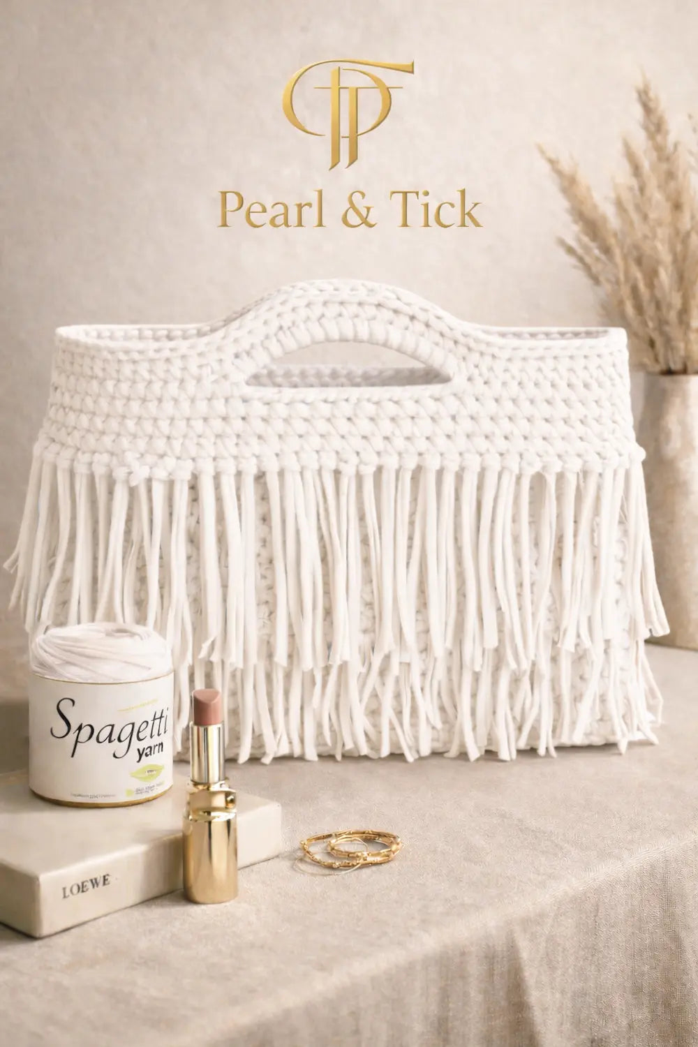 White woven basket with decorative items on a neutral background, featuring the brand 'Pearl & Tick'.