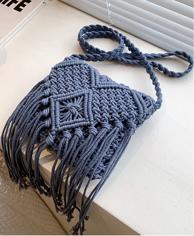 Blue macrame bag with tassels on a light surface