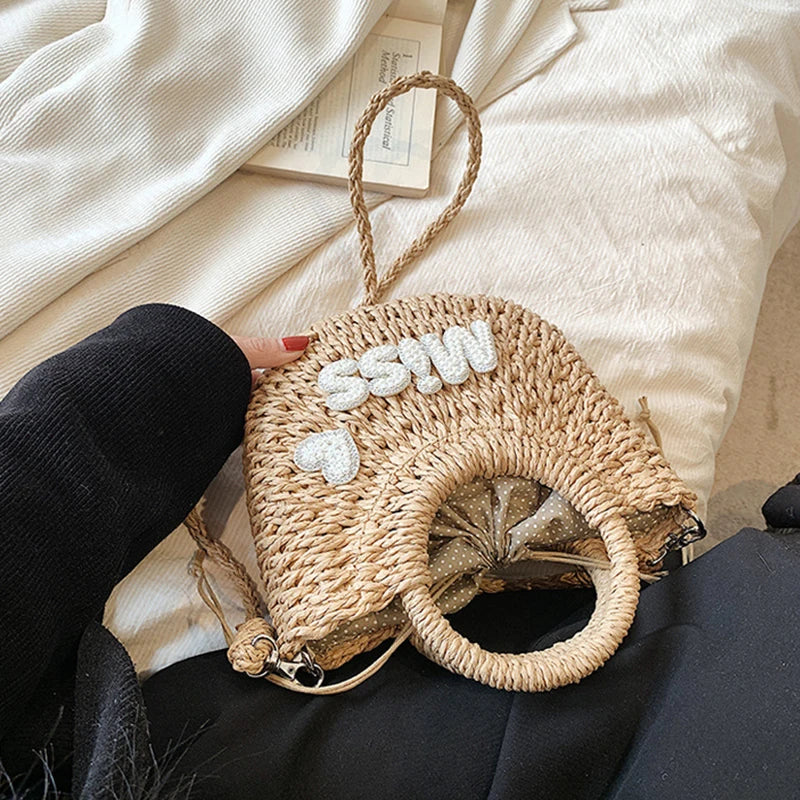 Woven handbag with decorative elements on a soft surface