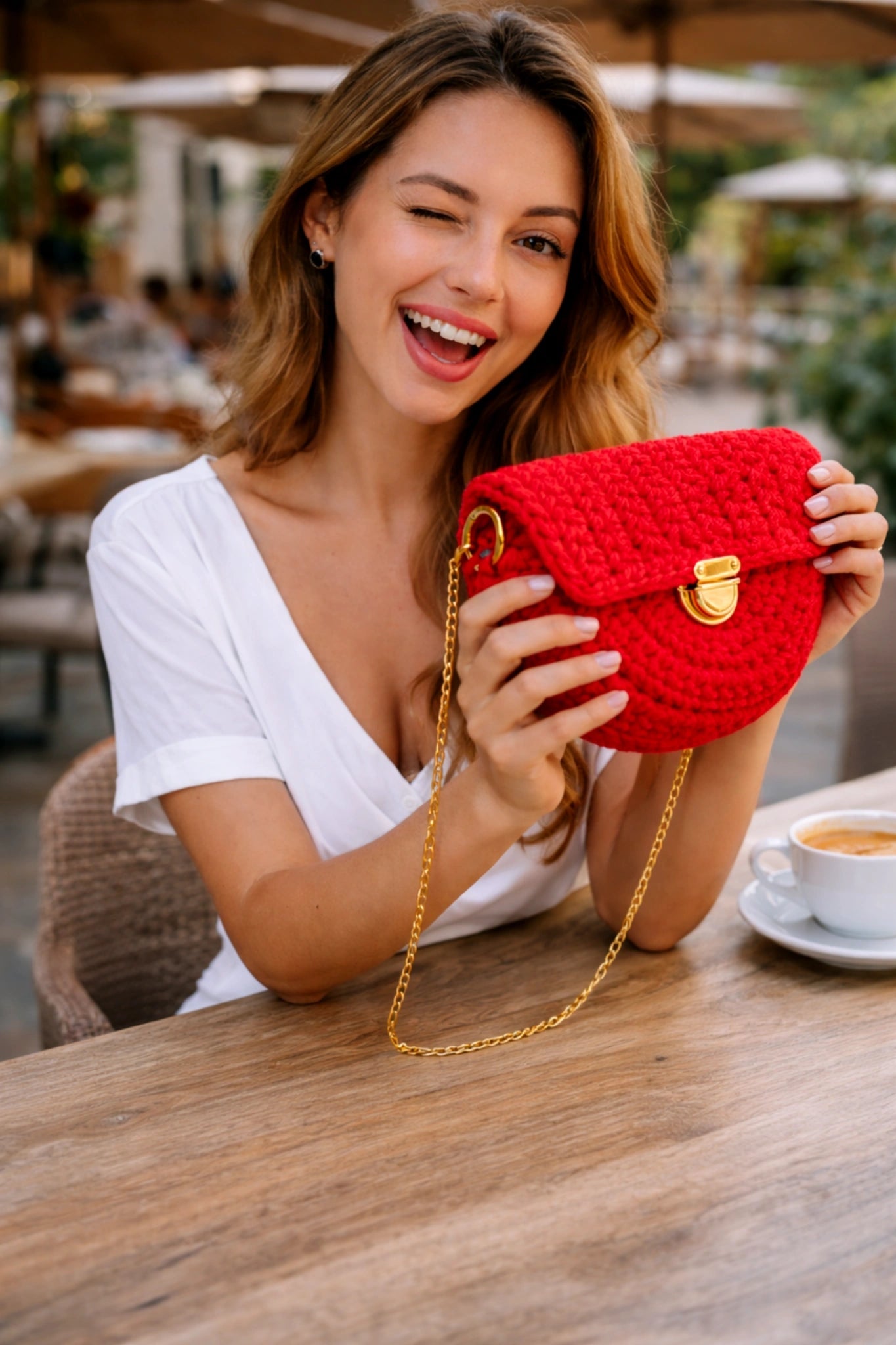 Luna Crescent Bag - Pearl & TickLuna Crescent BagHandbagsPearl & TickPearl & TickLUNA-REDRedWoman holding a red knitted purse in an outdoor setting