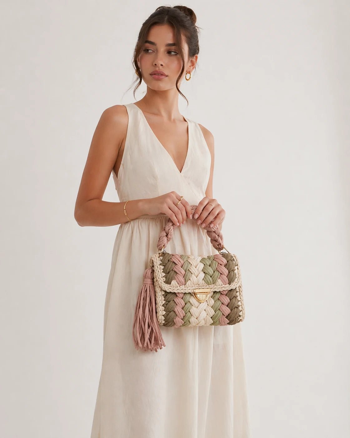 Pastel Dream Woven Handbag - Pearl & TickPastel Dream Woven HandbagHandbagsPearl & TickPearl & TickPASTEL-CMBcamel brownElegant woman holding a colorful woven handbag against a clean, minimalist background.