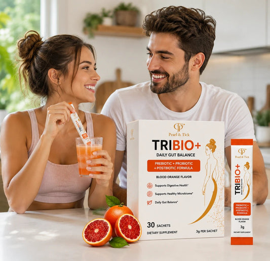 Couple enjoying TRIBIO+ dietary supplement with blood orange flavor in a kitchen setting.