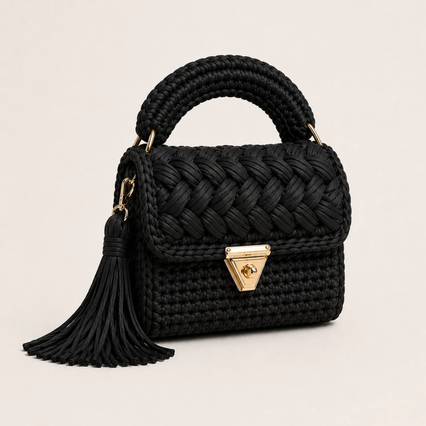 Velora Pearl Bag by Pearl & Tick — handcrafted black woven luxury handbag with elegant gold clasp and tassel.