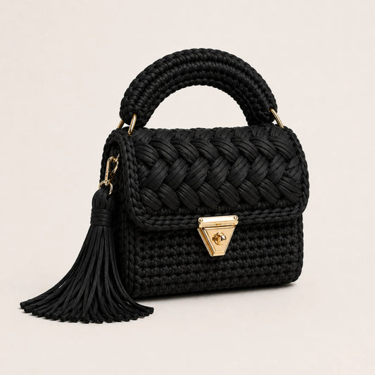 Velora Pearl Bag by Pearl & Tick — handcrafted black woven luxury handbag with elegant gold clasp and tassel.